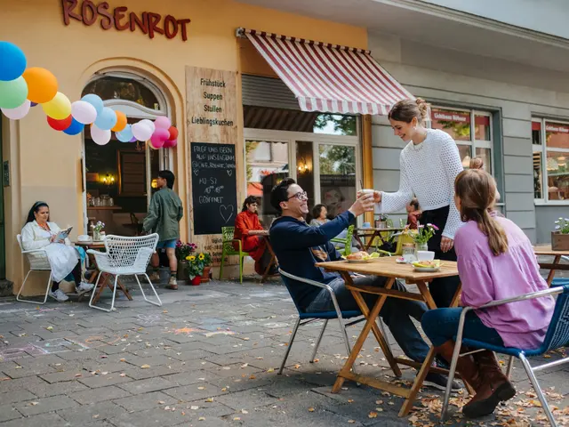 Nachbarn sitzen auf der Terrasse im Café Rosenrot in Berlin.